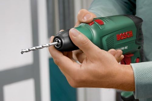 Hands inserting a drill bit into the keyless chuck of the Bosch drill