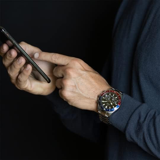 A person's hand wearing the JAGUAR Connected Collection J888/4 smartwatch, interacting with a smartphone, demonstrating the use of connected features.