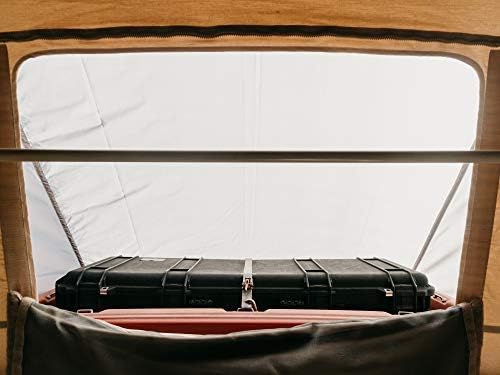 Interior view of the pop-top tent showing a storage box placed in the vestibule area created by the rainfly.