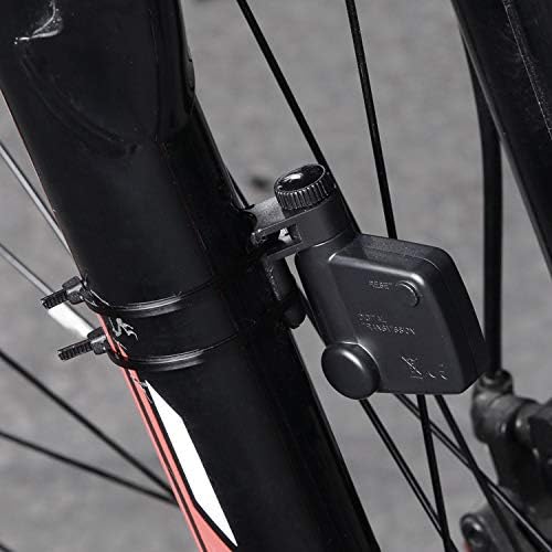 Close-up of the wireless transmitter and magnet installed on the bicycle's front fork and wheel spoke.