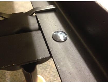 Close-up of a bed frame connection point with a bolt