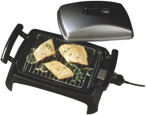 George Foreman GR55 Five Star Grill with three pieces of grilled fish on the cooking surface, garnished with herbs.