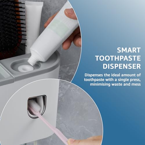 Image of Amazon Basics Wall-Mounted Toothbrush Holder with Automatic Toothpaste Dispenser | 1 Magnetic Cup | White | 20.5L x 10W x 14.5H cm