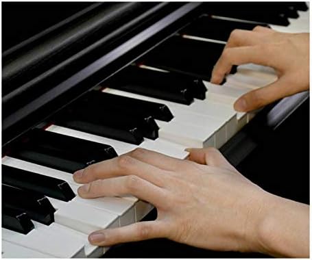 Close-up of hands playing the Yamaha YDP144 digital piano keys