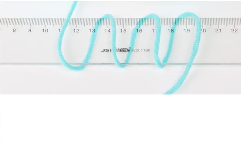 A strand of light blue yarn measured against a ruler, showing its approximate diameter of 2.5mm.