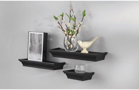 Three black floating shelves mounted on a wall, displaying decorative items
