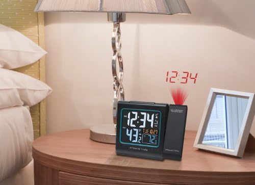 La Crosse Technology Alarm Clock on a nightstand projecting time onto the ceiling.