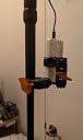 Holds firmly to tripod, versatile positioning, and holds a power bank