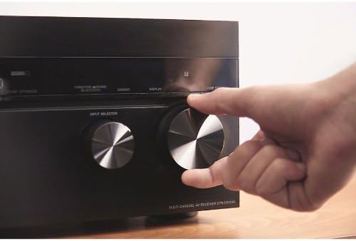 Hand adjusting the master volume knob on the Sony STR-DN1040 receiver