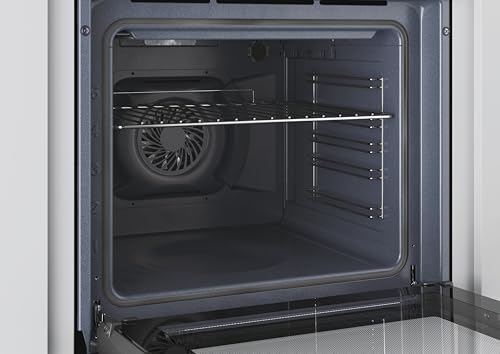 Interior del horno Candy FIDCP X625 L mostrando la rejilla de acero inoxidable y ventilador.