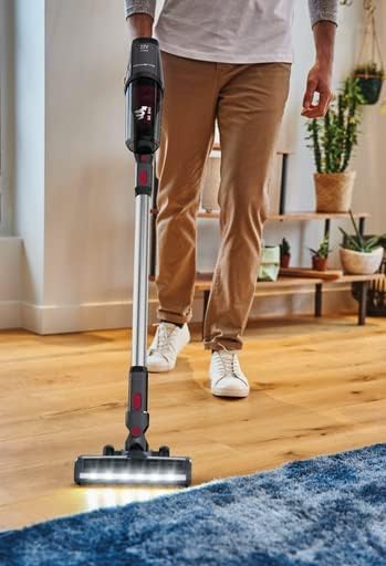 Tefal X-Pert 3.60 vacuum cleaner in use on a wooden floor with LED lights on