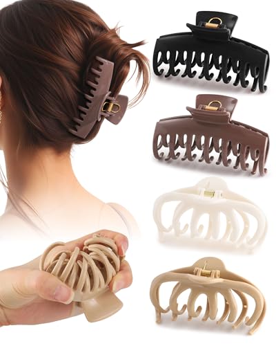 Four soft silicone double-row claw clips in neutral tones — the flexible body that reduces snag on release