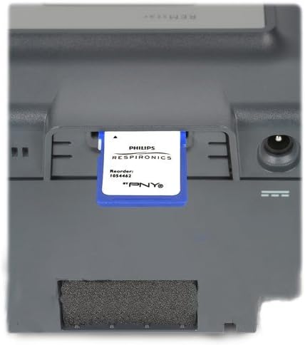 Respironics System One Data Card being inserted into a CPAP machine slot