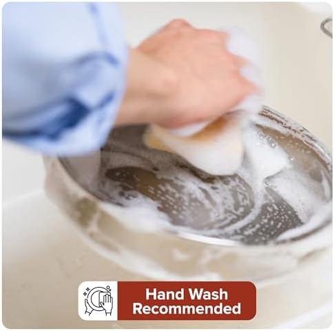 Chef pouring sauce from a Viking PureGlide Pro pan with ergonomic handle.