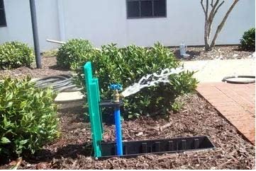 The Waterbox fully open with water spraying from the attached faucet.
