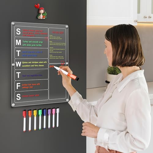 Woman writing on a clear acrylic magnetic weekly meal planner attached to a dark refrigerator.