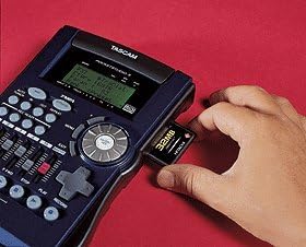 Hand inserting a 32MB memory card into the side slot of the Tascam Pocketstudio 5