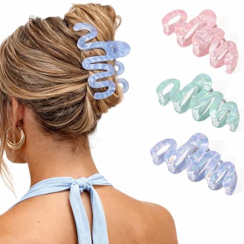 Three pastel wavy claw clips in blue, pink and green — acetate rather than moulded plastic