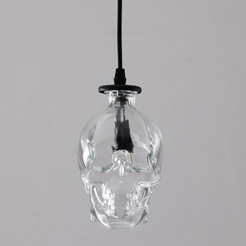 Lámpara de calavera de cristal negro con acabados industriales de lujo