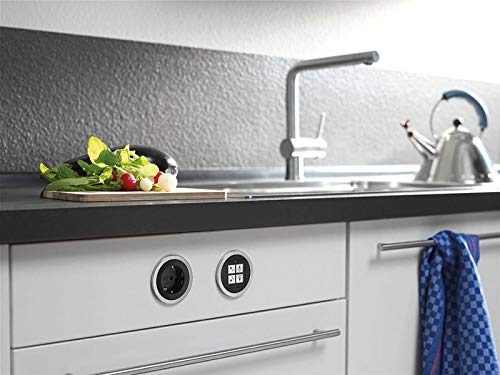 Two BACHMANN PIX Built-in Sockets integrated into a modern kitchen countertop, one with a power outlet and the other with a data module, demonstrating a clean and functional installation.