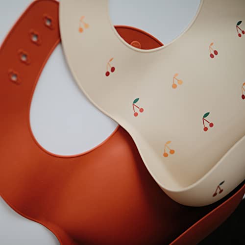 Image of mushie Silicone Baby Bib | Adjustable Fit Waterproof Bibs (Cherries)