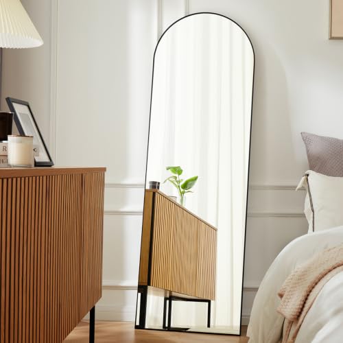 Black arched 63-inch DUMOS floor mirror standing against a wall — the tallest panel here and the only one that needs no drilling