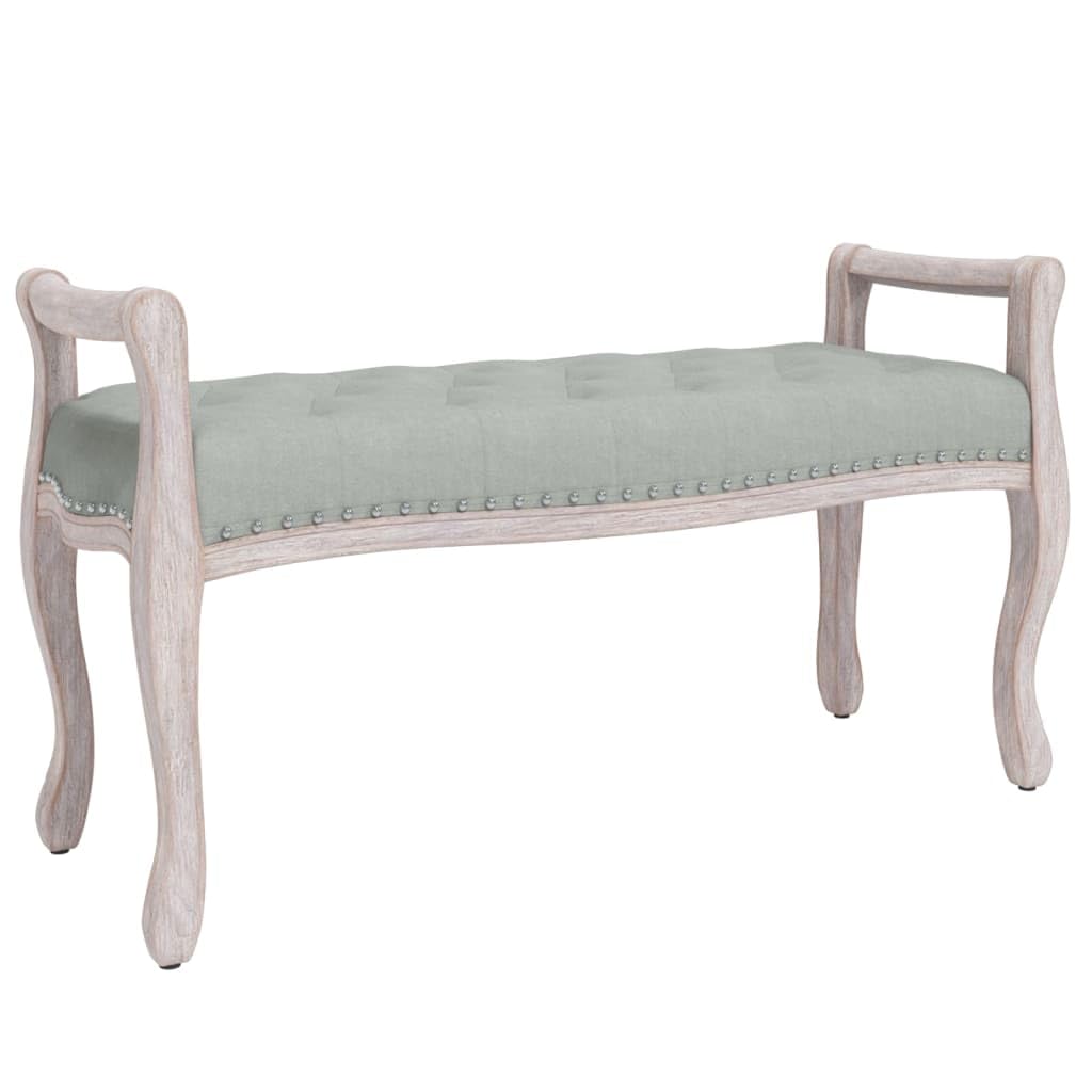 Sillón tapizado en terciopelo gris con acabados premium y patas de madera vintage