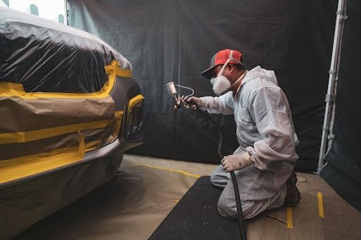 Close-up of Apollo HVLP spray gun in action