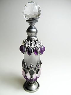 Antique refillable perfume bottle embossed with purple stones decoration and rhinstone screw cap and rod.