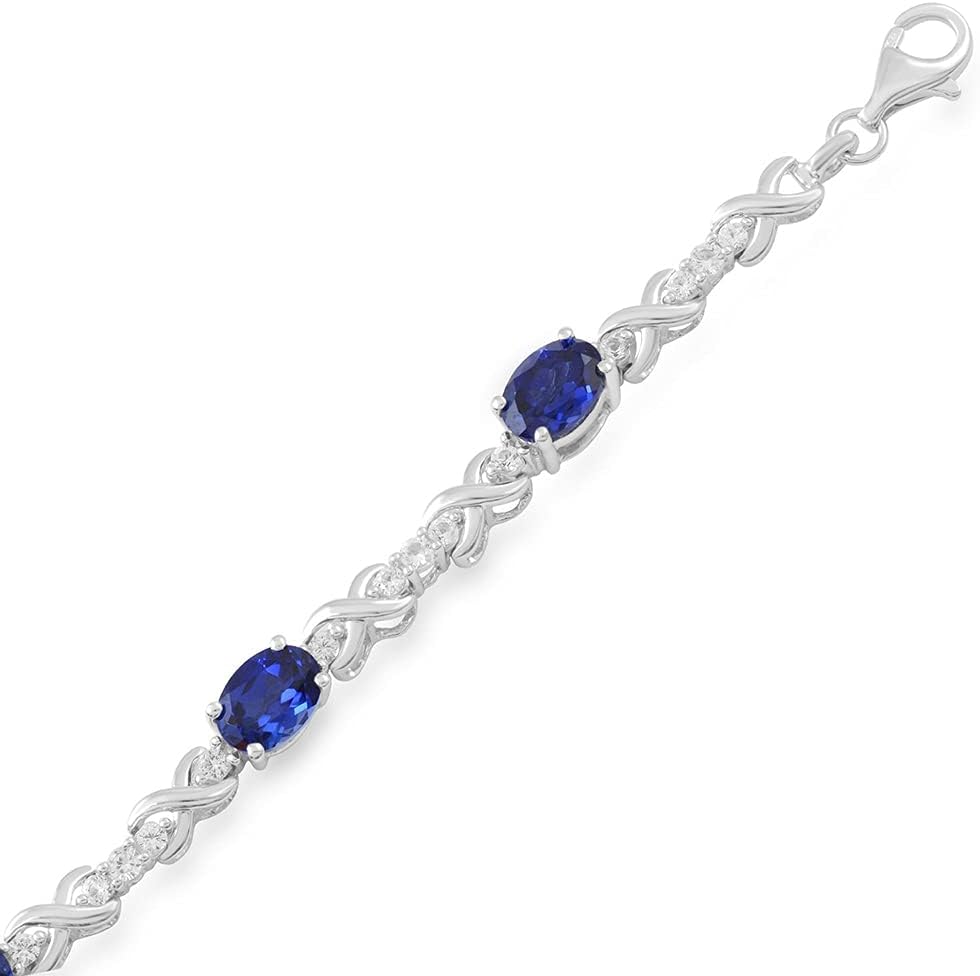 Jewelili Sterling Silver 7x5 MM Oval Shape Created Blue Sapphire and Round Created White Sapphire Link Bracelet, 7.25"