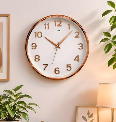 Image of Amazon Brand - Solimo 12 Inches Silent Wall Clock for Living Room Bedroom Office Plastic Easy to Read 3D Numbers Modern Stylish Sweep Movement Wall Clock for Home 1603DX (Rose Gold)