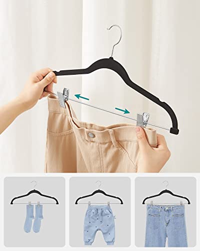 Image of SONGMICS Trouser Hangers, Set of 12 Velvet Hangers with Adjustable Clips, 42.5 cm Long, Non-Slip, Space-Saving, for Skirts, Coats, Dresses, Black CRF12B | Space Saving Hangers for Skirts and Trousers, Non-Slip, Adjustable Clips, Ink Black, BREANNA Collection CRF12B