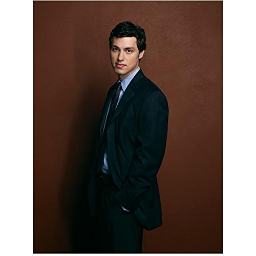 Bones John Francis Daley Standing in Dark Suit Hands in Pockets in Front of Red Wall Promo 8 x 10 Photo