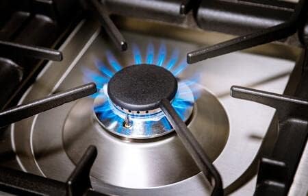 Another close-up of a sealed brass burner with blue flame on the Ilve Nostalgie Series range.