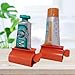 XYKEEY Set of 2 Toothpaste Squeezer Rollers, Metal Toothpaste Tube Wringer Seat Holder Stand (Orange)