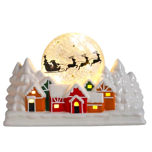 Scena illuminata del villaggio di Natale con slitta di Babbo