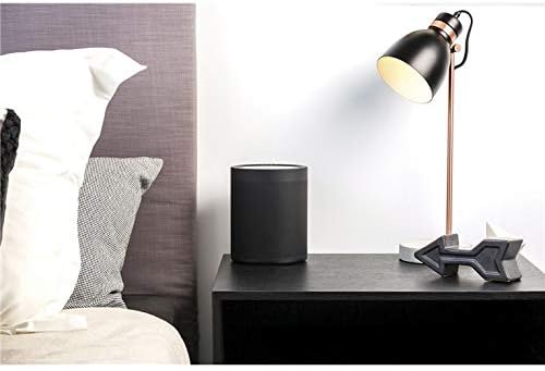 Yamaha MusicCast 20 speaker placed on a bedside table next to a lamp