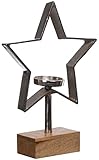 DESIGN: Ce bougeoir exceptionnel se compose d'une étoile en métal argenté sur un socle en bois précieux.