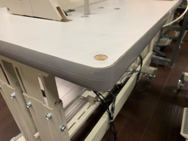 Close-up of the tabletop corner, showing the thickness and finish of the material.