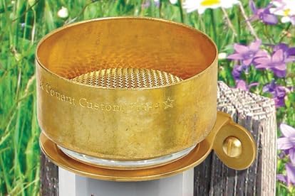 Close-up view of the rain gauge's brass collection funnel with a metal screen to filter debris.