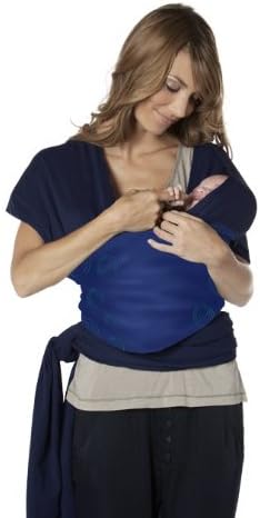 Parent adjusting a baby in a front-carry, inward-facing position using the CYBEX u.GO carrier.