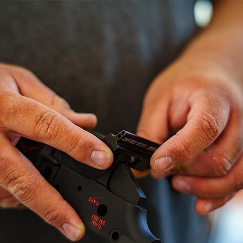 Hands installing a trigger guard using the Wheeler tool on an AR-15 lower receiver