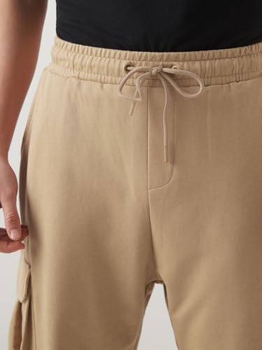 Image of Bewakoof Men's Cotton Super Loose Fit Joggers|Bewakoof Air 1.0 | Track pants for man | Lower for man | Trouser for men | Baggy trackpants for men | Multipurpose | Mens Lower Activewear | Utility Pockets | Lightweight & Flexible Elastic Waist | Casual Joggers | Loose Fit