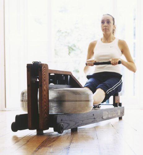 Lady at home working out on a WaterRower Club Rowing Machine