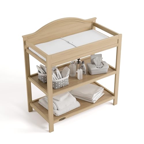 Image of Graco Story Changing Table with Water-Resistant Pad - GREENGUARD Gold Certified Baby Changing Station with Safety Strap, 2 Open Shelves, and a Nursery Must-Have Design (Driftwood)
