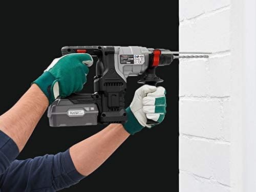 User hammer drilling into a concrete wall with the rotary hammer drill