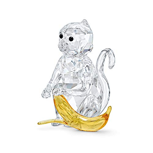 Questa incantevole statuetta Swarovski è realizzata in cristallo bianco a forma di scimmia con una banana in cristallo giallo scintillante