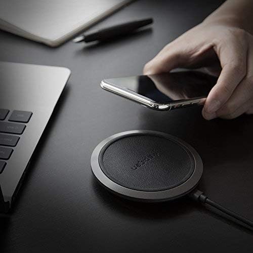 Hand placing phone on Spigen Wireless Charger