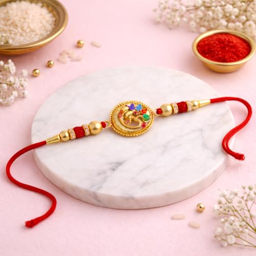 Image of JAIPUR ACE Designer Gold Plated Om Rakhi with Multicolor Stones - Premium Raksha Bandhan Thread for Brother, Elegant Ganesha Rakhi with Red String, Beads & Festive Traditional Finish (Golden Om rakhi)