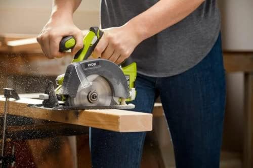 Man operating a circular saw to cut wood outdoors